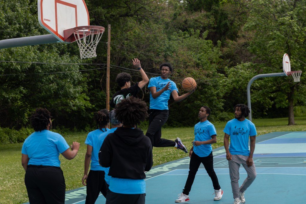 Students play basketball during the May Day celebration at Fairmount Park in Philadelphia.