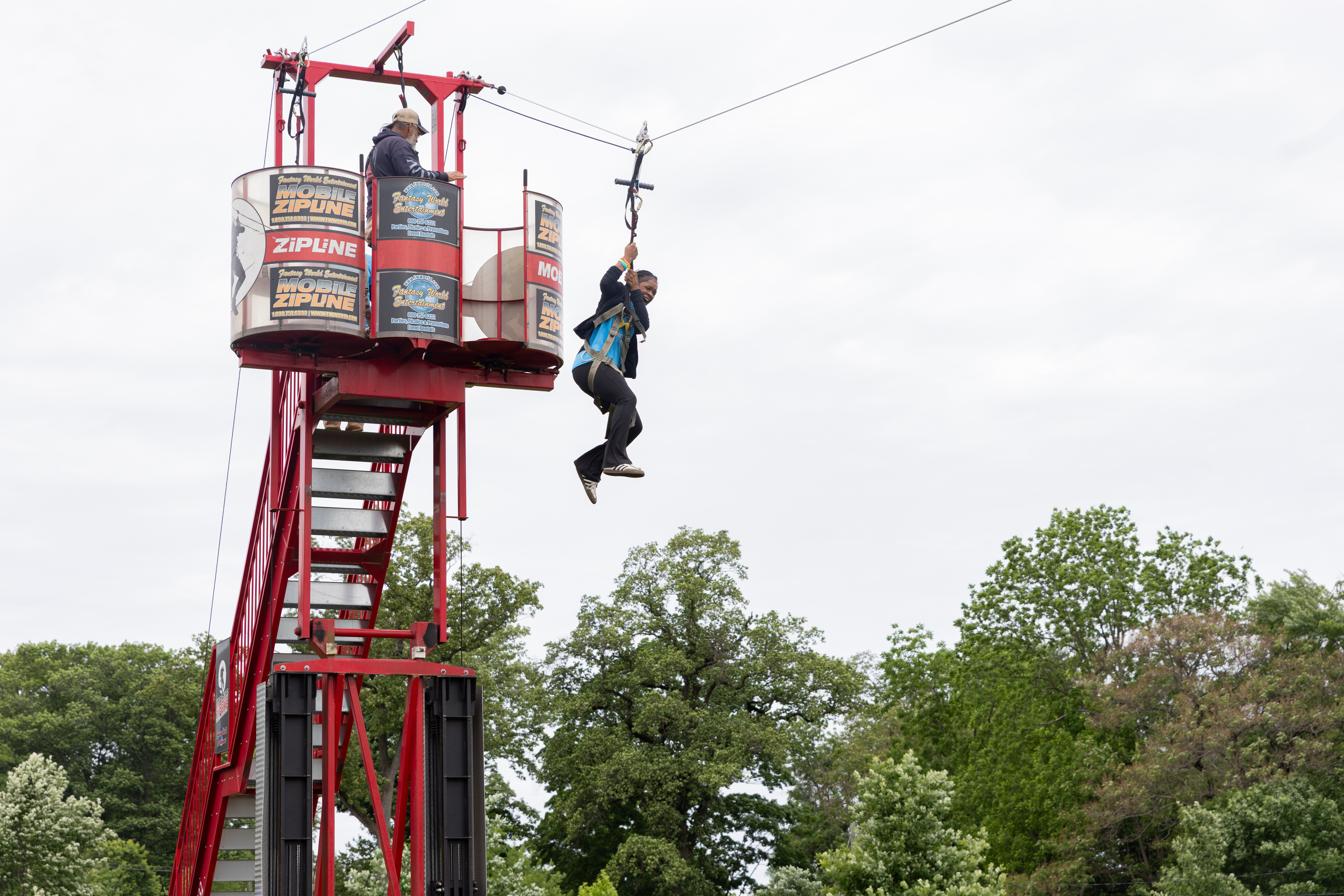 A student rides a zip line during the May Day celebration at Lemon Hill Picnic Area.