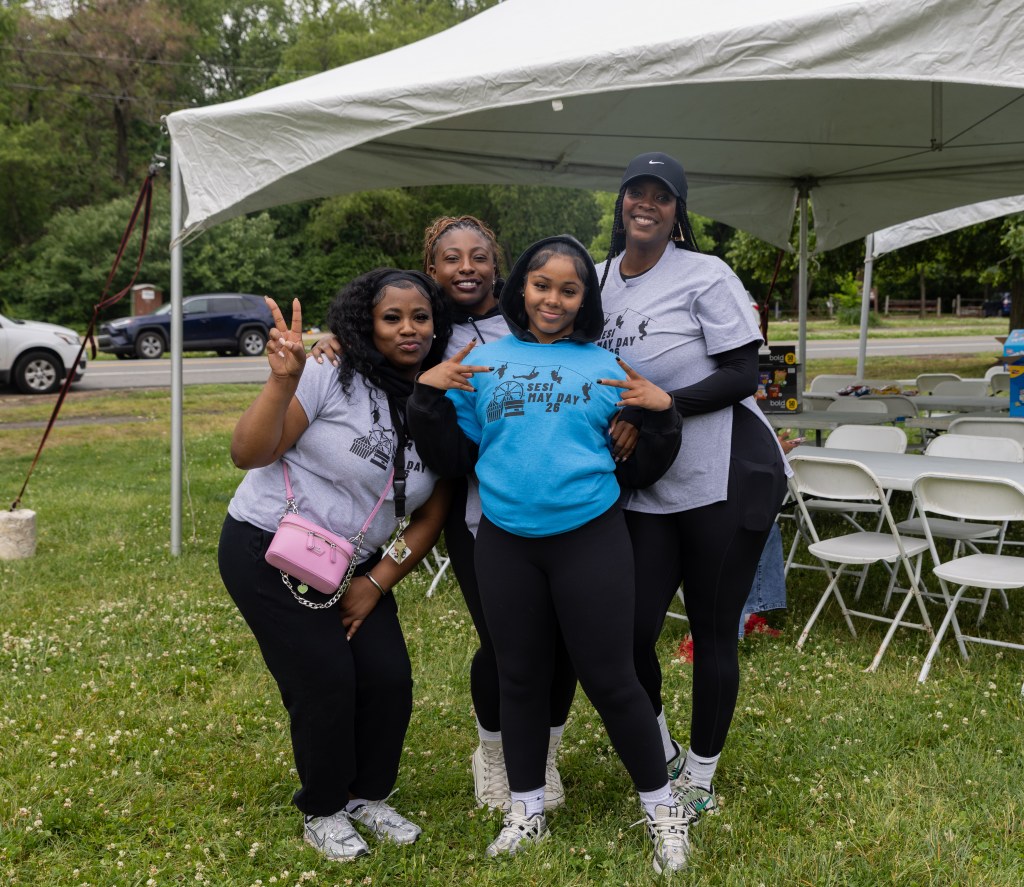 Students and staff pose together during the Philadelphia May Day celebration.