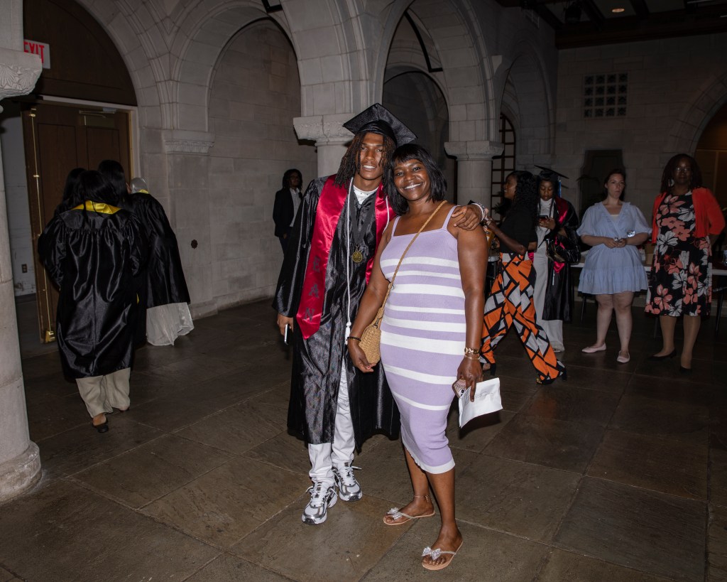 Philadelphia graduate poses with a family member following the Class of 2026 ceremony.
