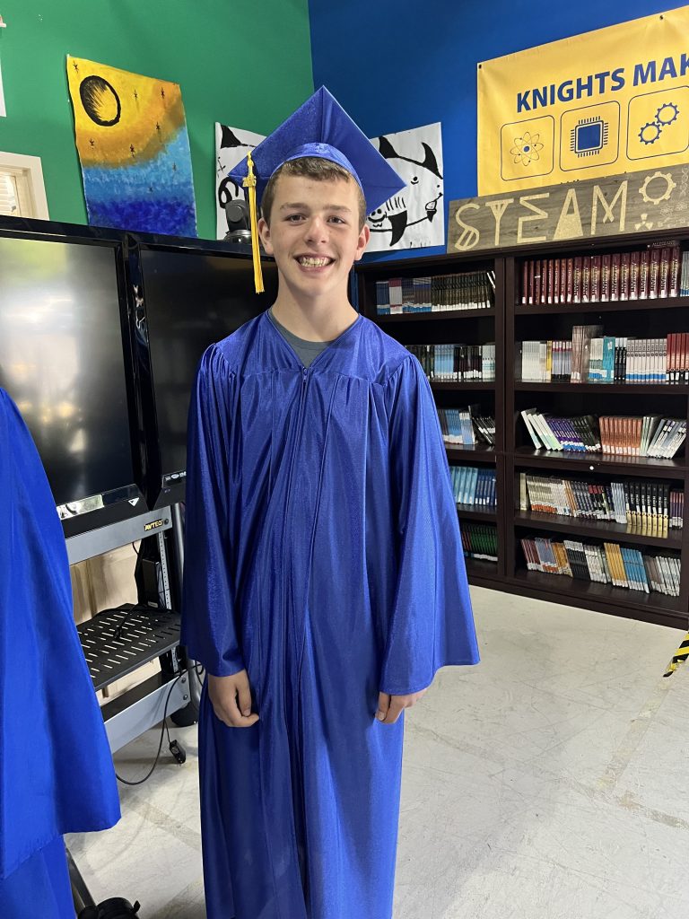 Bobby smiles in his graduation cap and gown at High Road School of Naperville after stepping outside his comfort zone and embracing new opportunities.