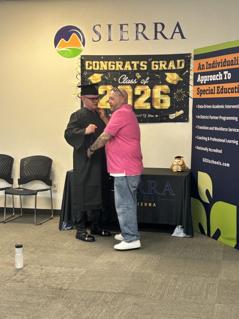 A Sierra School of Gilbert graduate shares a celebratory moment with a family member following the Class of 2026 ceremony.