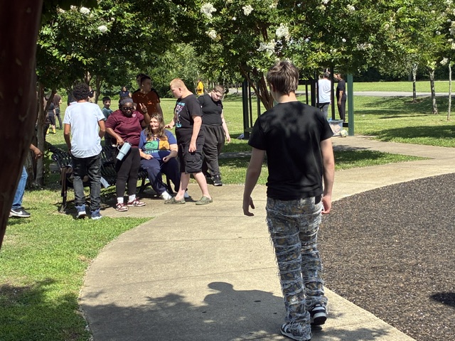 Students spend time together near the playground during a High Road School of Nashville park field trip.