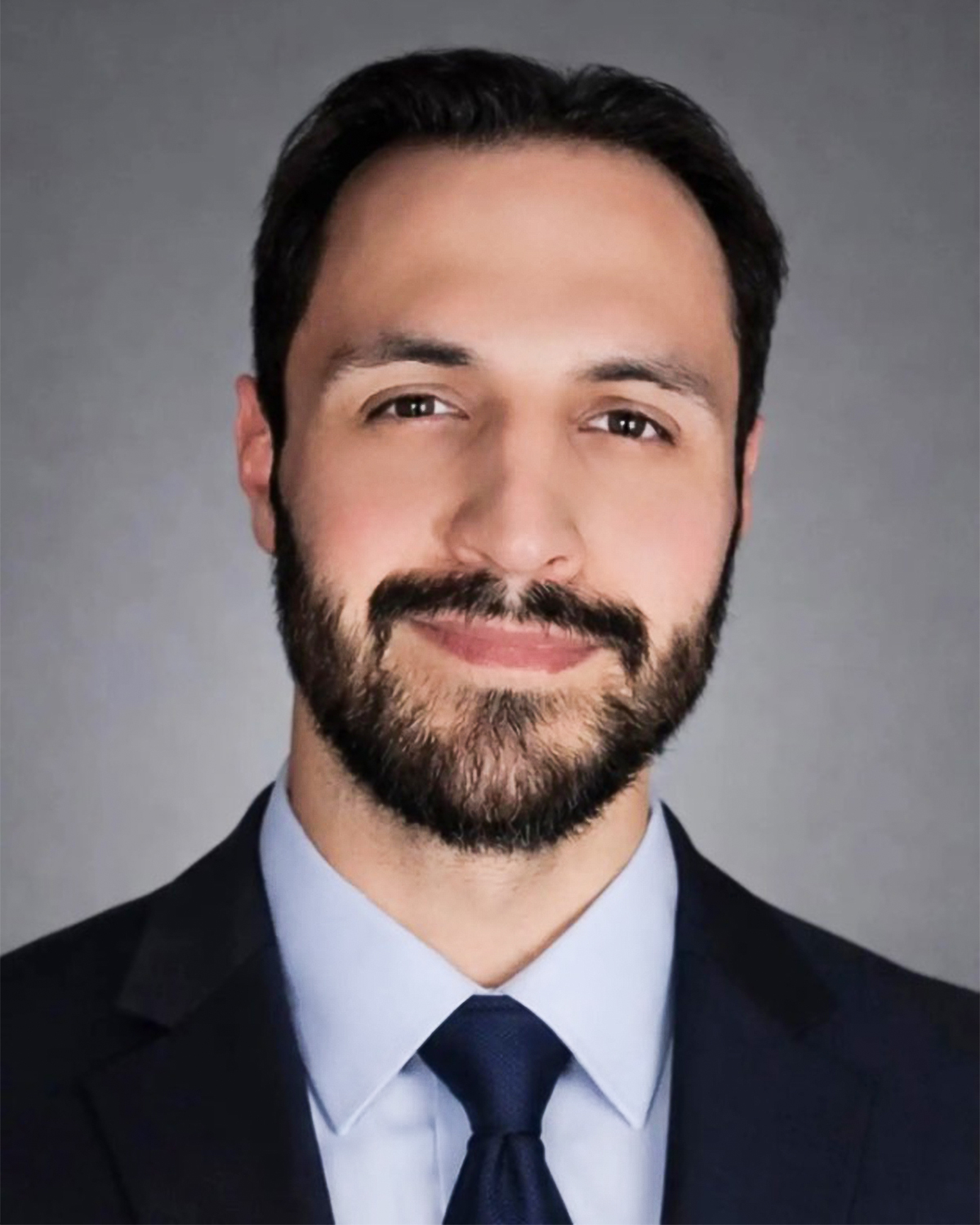 Mitchell Jordan smiling in a professional staff headshot
