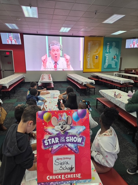 Students gather for a group activity during their STEAM field trip to Chuck E. Cheese.
