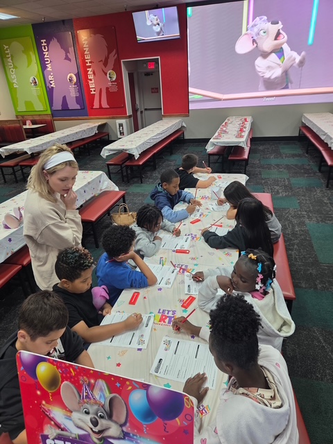Students complete interactive learning activities while celebrating their visit to Chuck E. Cheese.