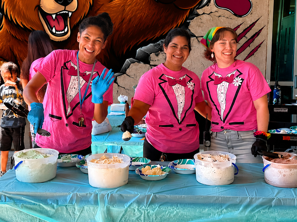 Sierra School of Sacramento staff serve ice cream to students during a summer school activities celebration.