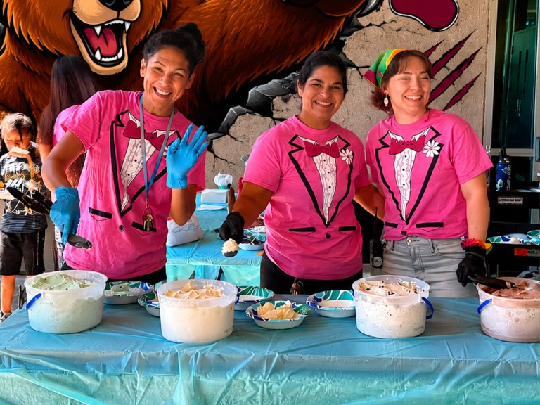 Sierra School of Sacramento staff serve ice cream to students during a summer school activities celebration.