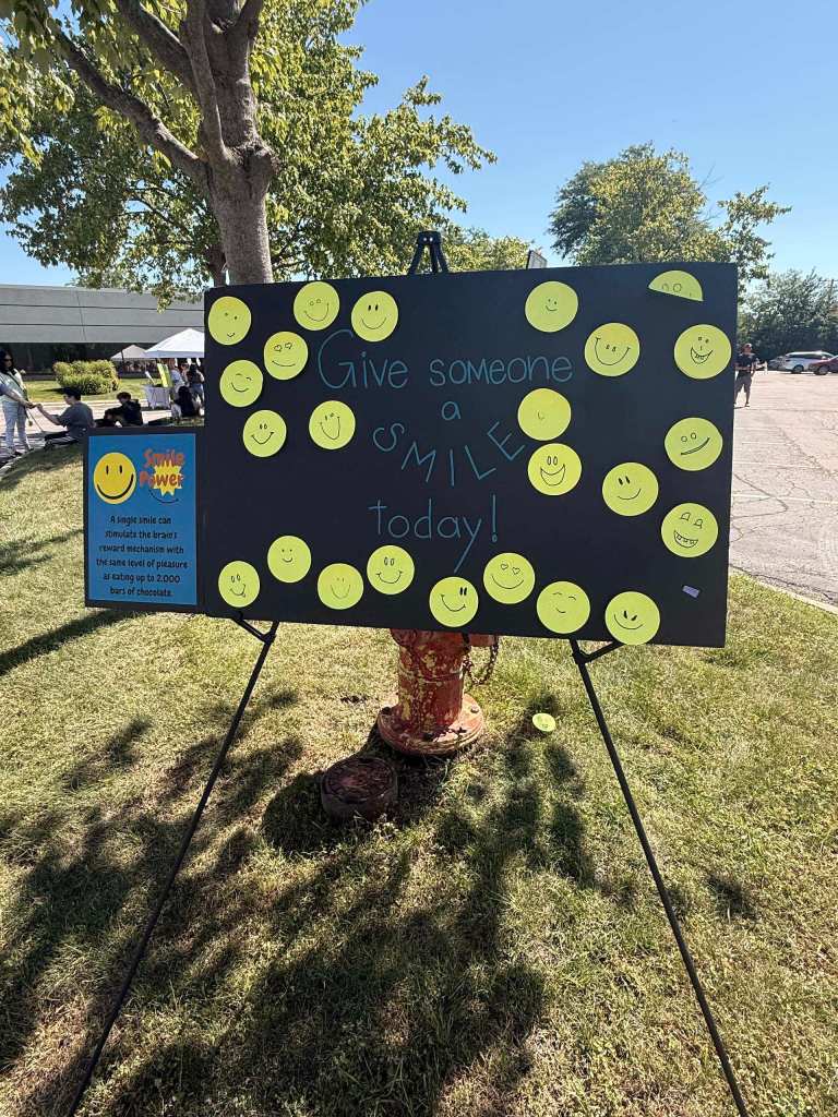 Student mental health fair display inviting attendees to give someone a smile.