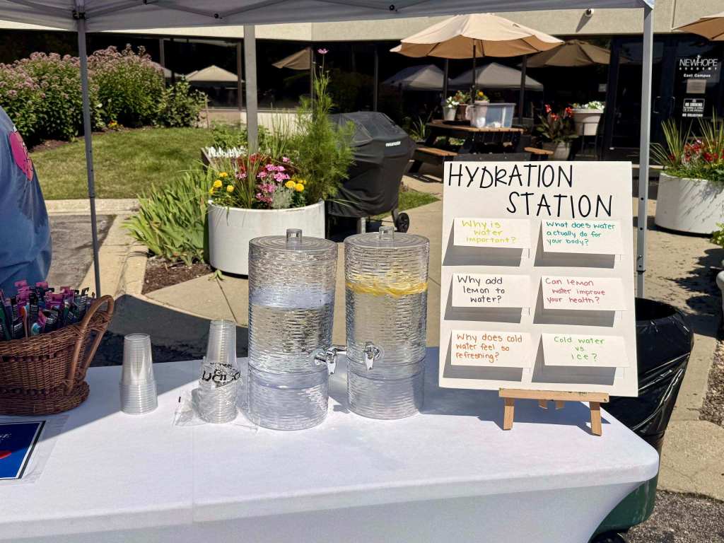 Hydration station with water dispensers and an interactive display about the health benefits of water.