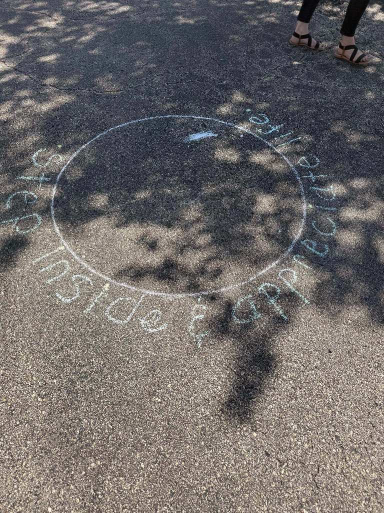 Chalk wellness activity asking attendees to share something they are grateful for.