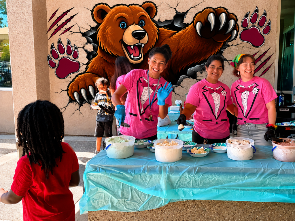 Sierra School of Sacramento staff serve ice cream to students during a summer school activities celebration.