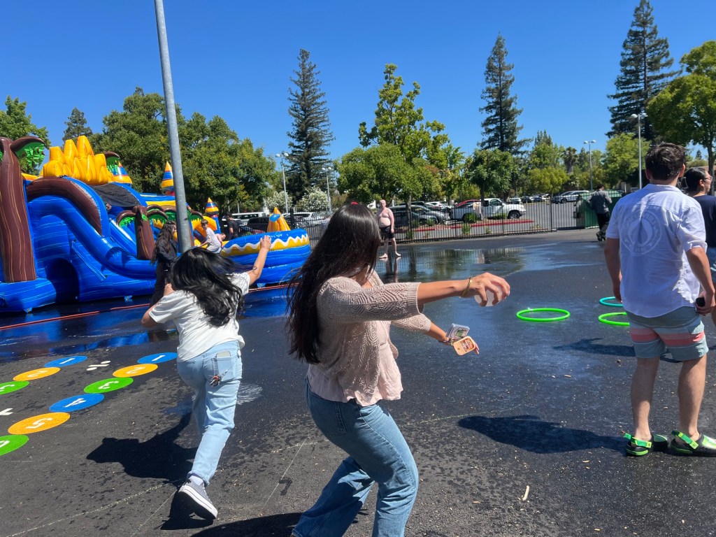 Students and staff participate in outdoor water games during summer programming at Sierra School of Sacramento.