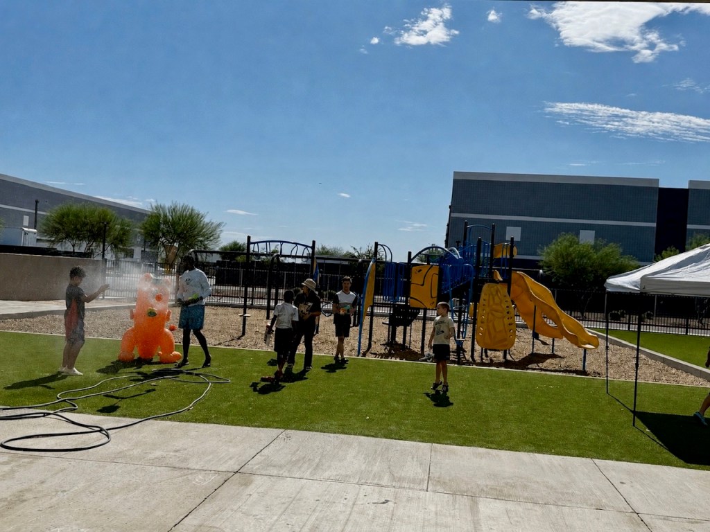 Students enjoy an outdoor water activity on the playground during an ESY celebration at Sierra Schools of Arizona.