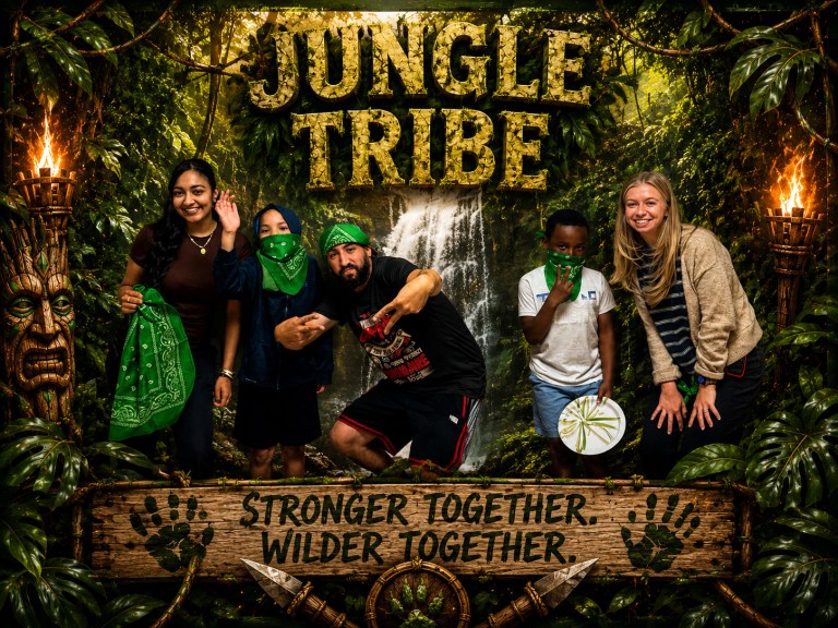 Students and staff representing the green Jungle Tribe pose together after completing team challenges.