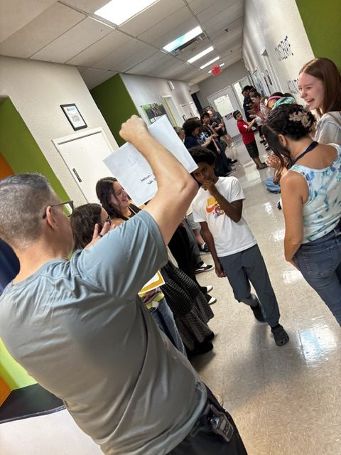 A Sierra Gilbert student walks through a cheering hallway during the school’s monthly respect recognition celebration.