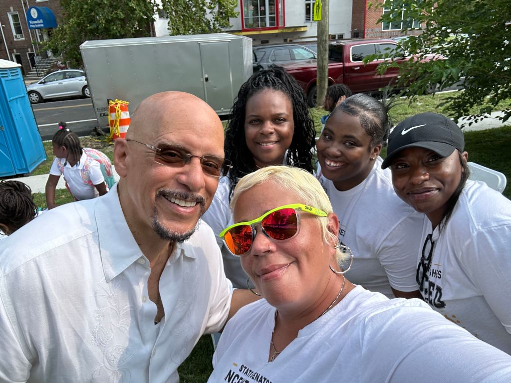 Event volunteers pose together during the Packed for Success back-to-school event in Philadelphia.
