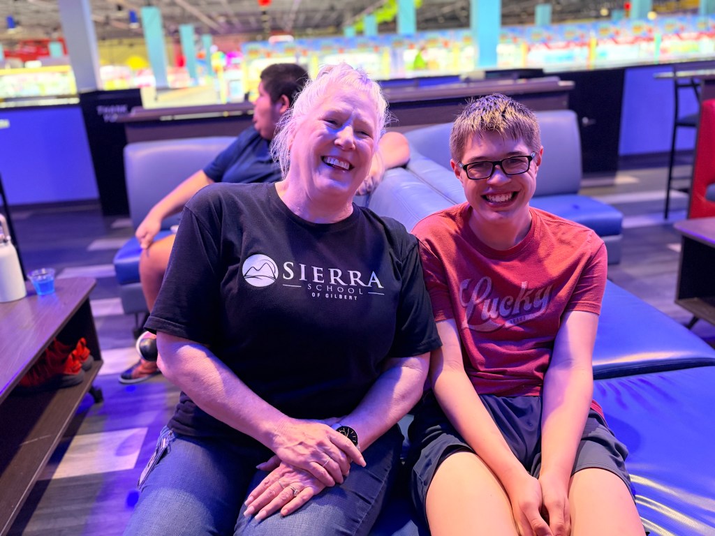 Sierra Gilbert staff member and student smile together during the Fun Friday bowling trip.