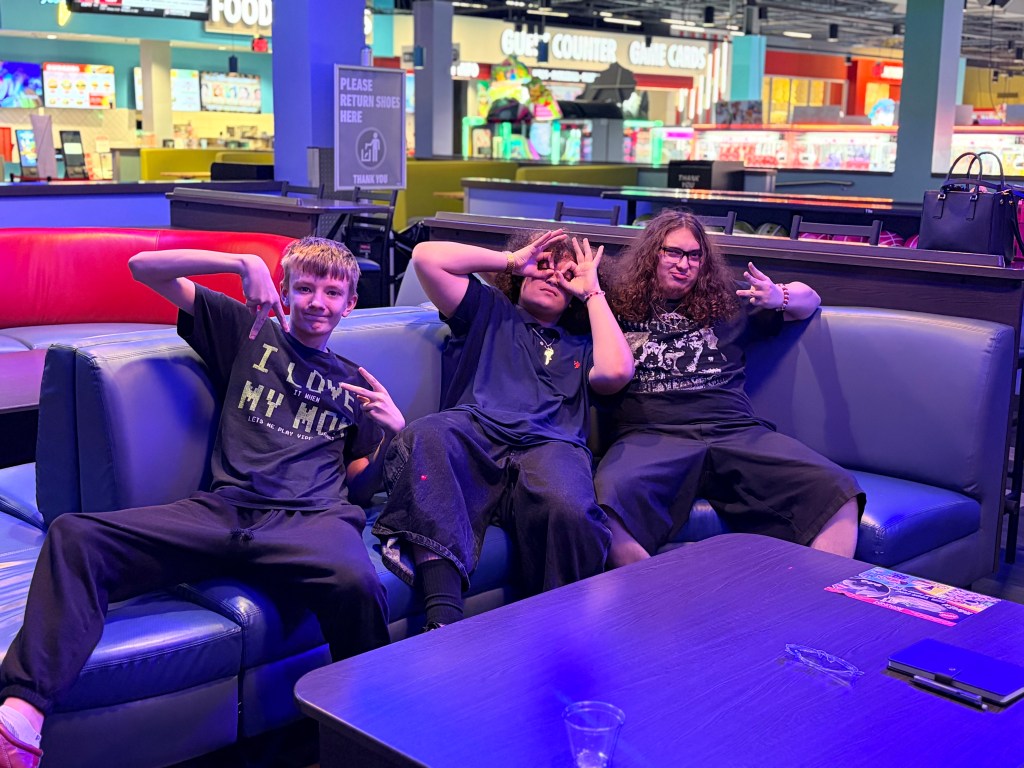 Three Sierra Gilbert students relax together during their Fun Friday trip to Round1.