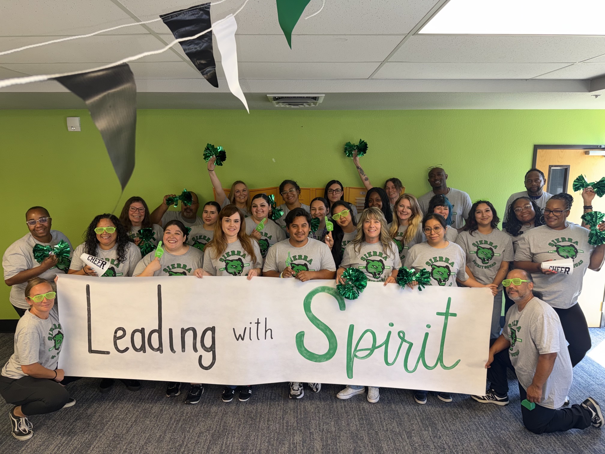 Sierra School of Solano County staff gather behind a “Leading with Spirit” banner during new school year preparation.