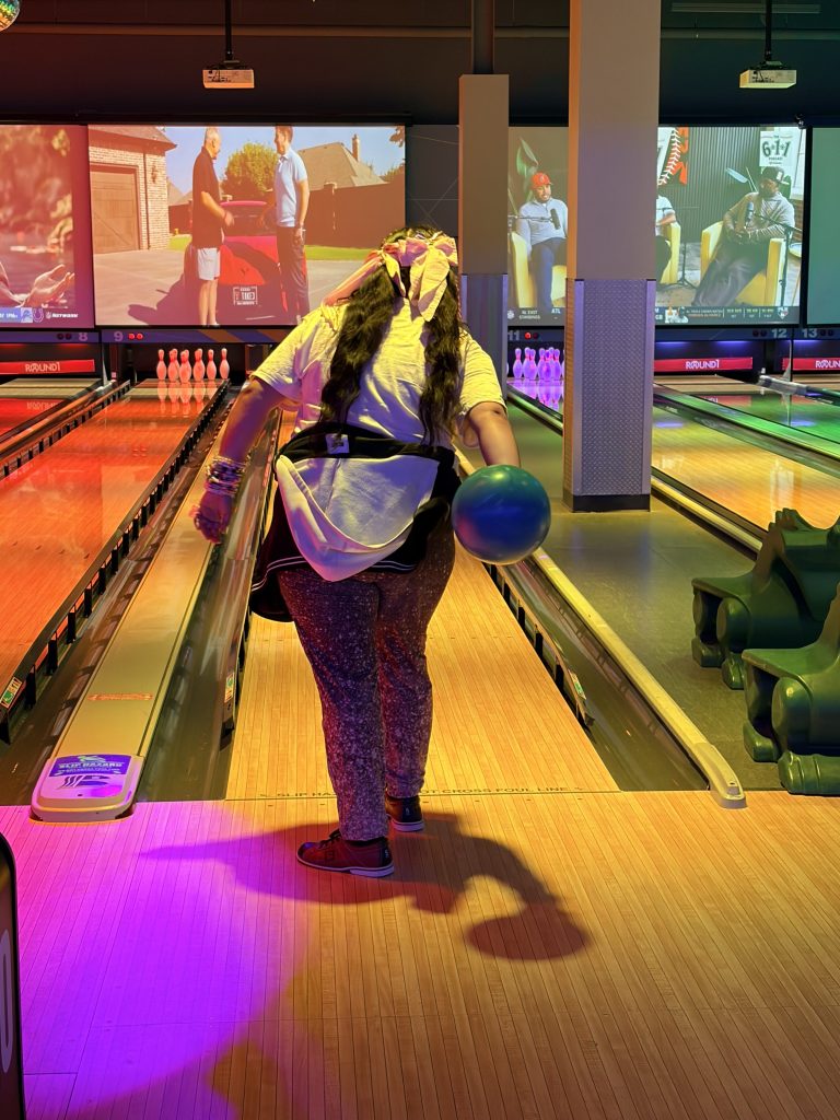 Sierra Gilbert student holds a bowling ball while participating in the school’s Fun Friday outing.