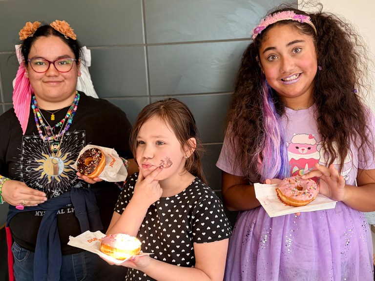 Sierra Gilbert Girls Club students enjoy donuts together during a birthday celebration and community outing.