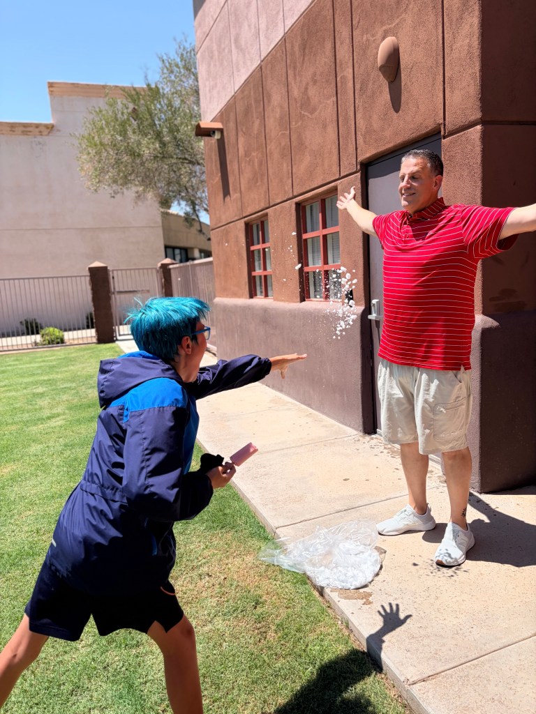 Sierra School of Gilbert student throws a snowball toward a staff member during the Fun Friday celebration.