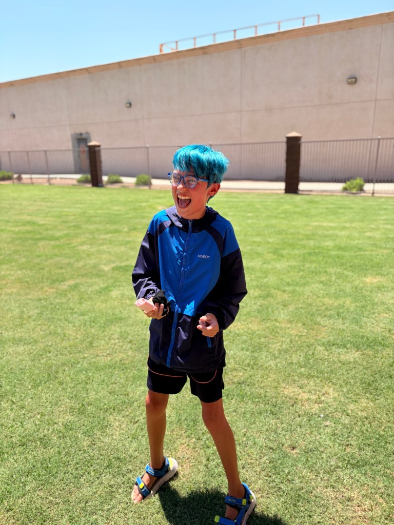 Student smiles while holding a snowball during the Sierra School of Gilbert Fun Friday event.