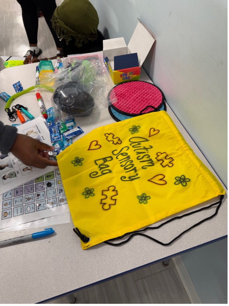 Yellow sensory bag decorated by BEST Academy staff with autism awareness designs