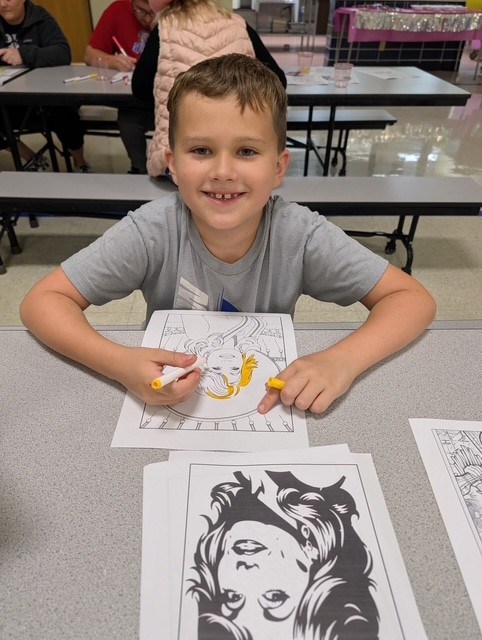 Student colors a Dolly Day activity at Northwest Center for Autism at High Road School