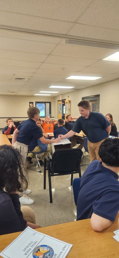 High Road students presenting a classroom norms poster they created together