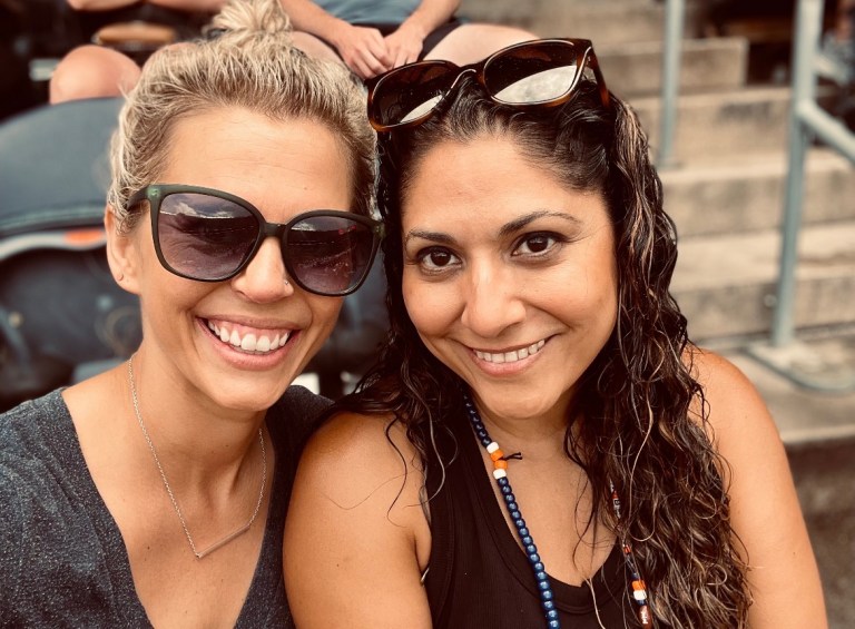 Bethany Arteaga and Meaghan Torrence smiling together at an outdoor event