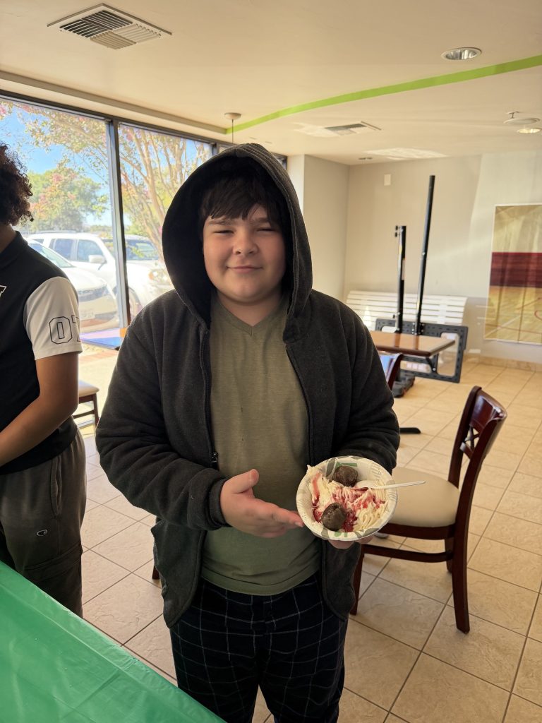 Sierra School of Solano County student displays a completed bowl of spaghetti ice cream during the school activity.