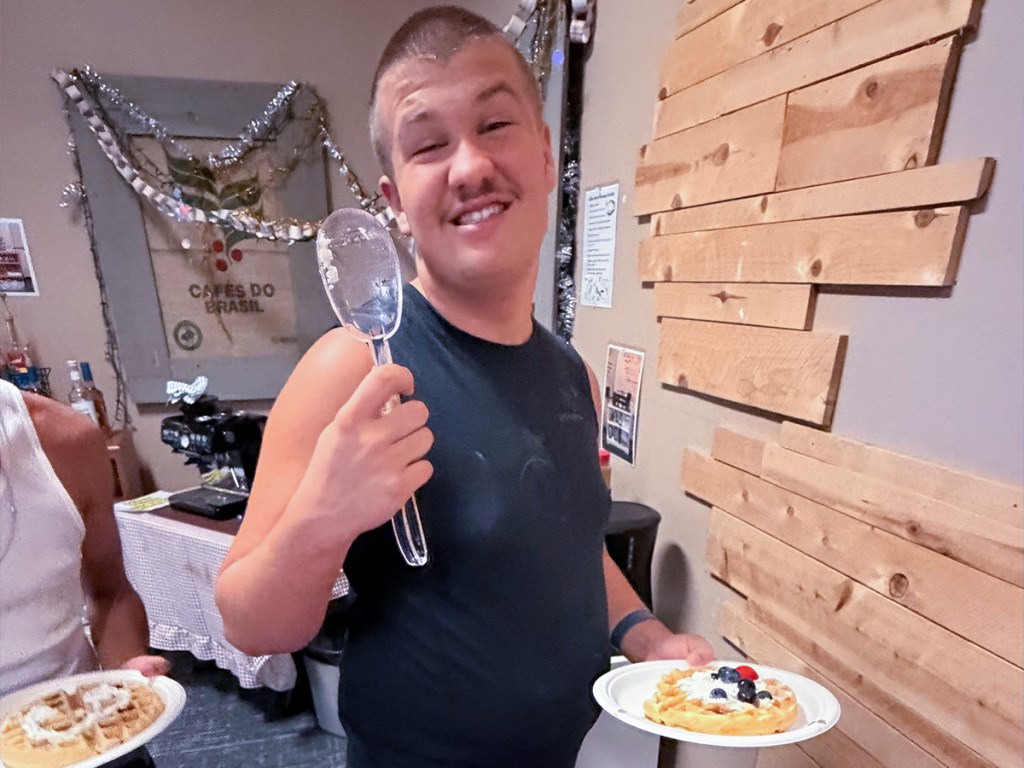 1. Sierra School of San Diego student prepares a waffle while practicing restaurant and workplace skills.