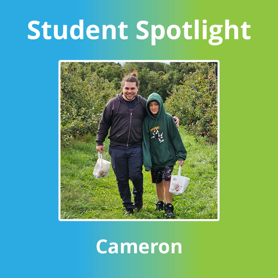 High Road School of Wallingford student Cameron B. posing with a staff member during an apple orchard field trip.