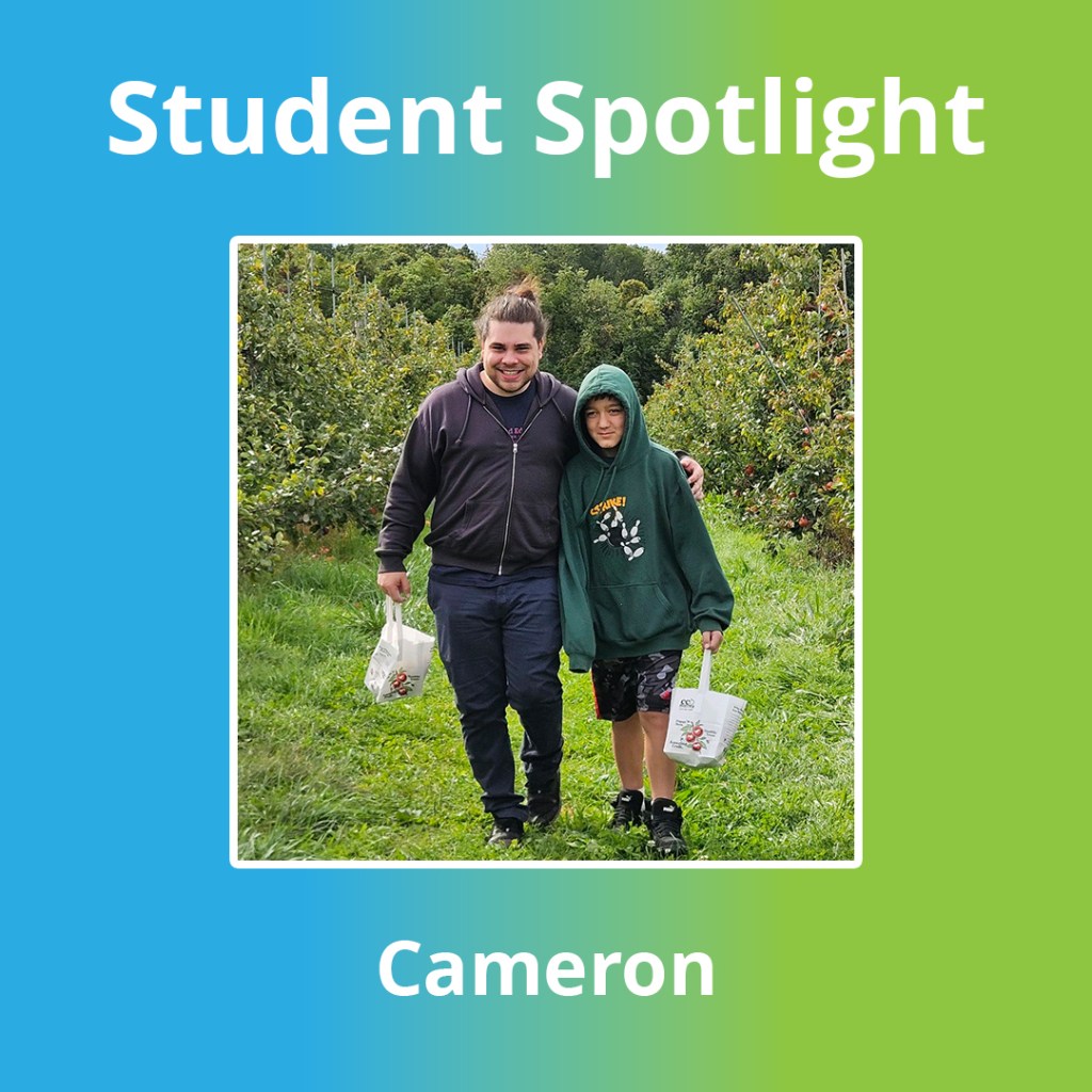 High Road School of Wallingford student Cameron B. posing with a staff member during an apple orchard field trip.