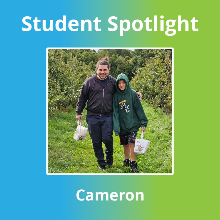 High Road School of Wallingford student Cameron B. posing with a staff member during an apple orchard field trip.