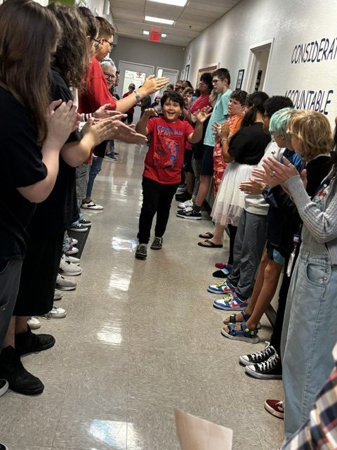 Los alumnos y el personal de la Sierra School de Gilbert aplauden a un alumno que atraviesa el «Túnel de la Victoria», que se celebra cada semana.