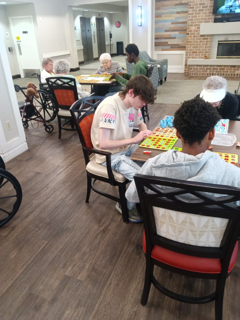 High Road School of Baltimore County students playing bingo with residents at Oak Crest Senior Living Community.