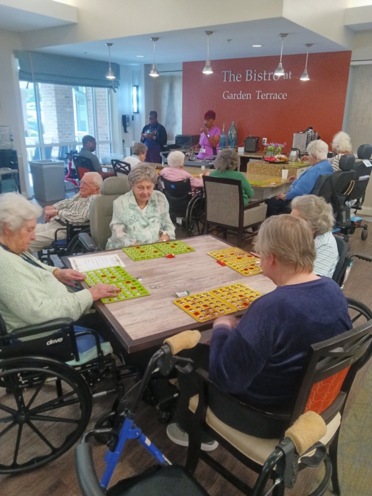 Oak Crest residents participating in bingo during a visit with High Road School of Baltimore County students.