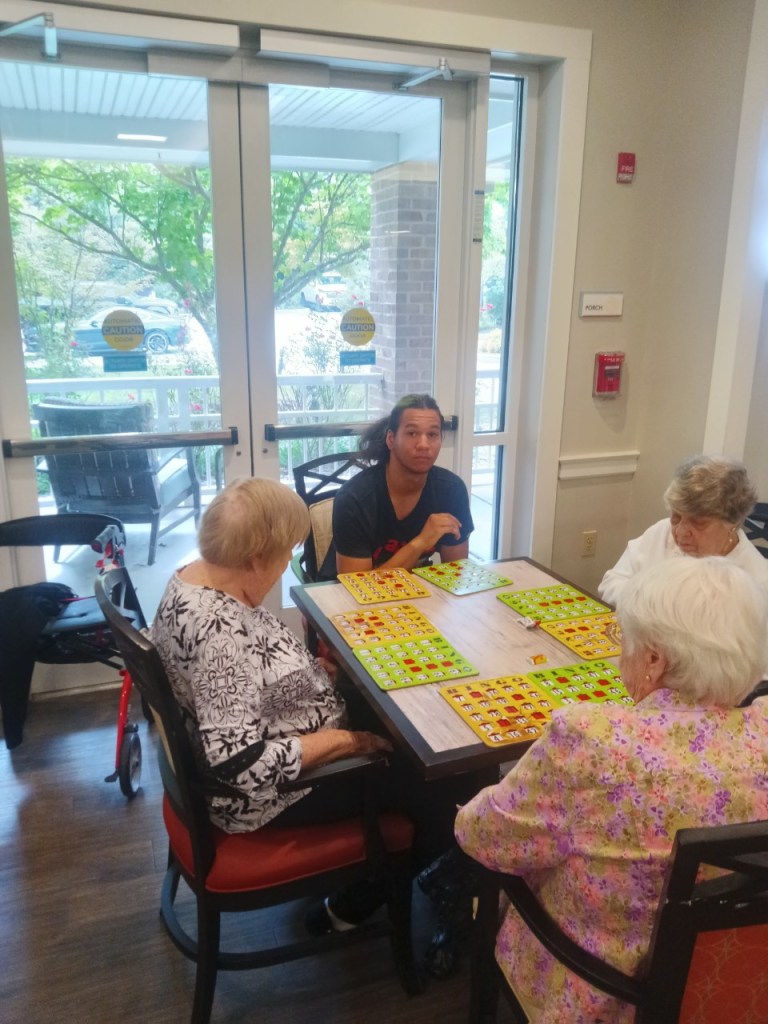 1. High Road School of Baltimore County student spending time with Oak Crest residents during a community service visit.