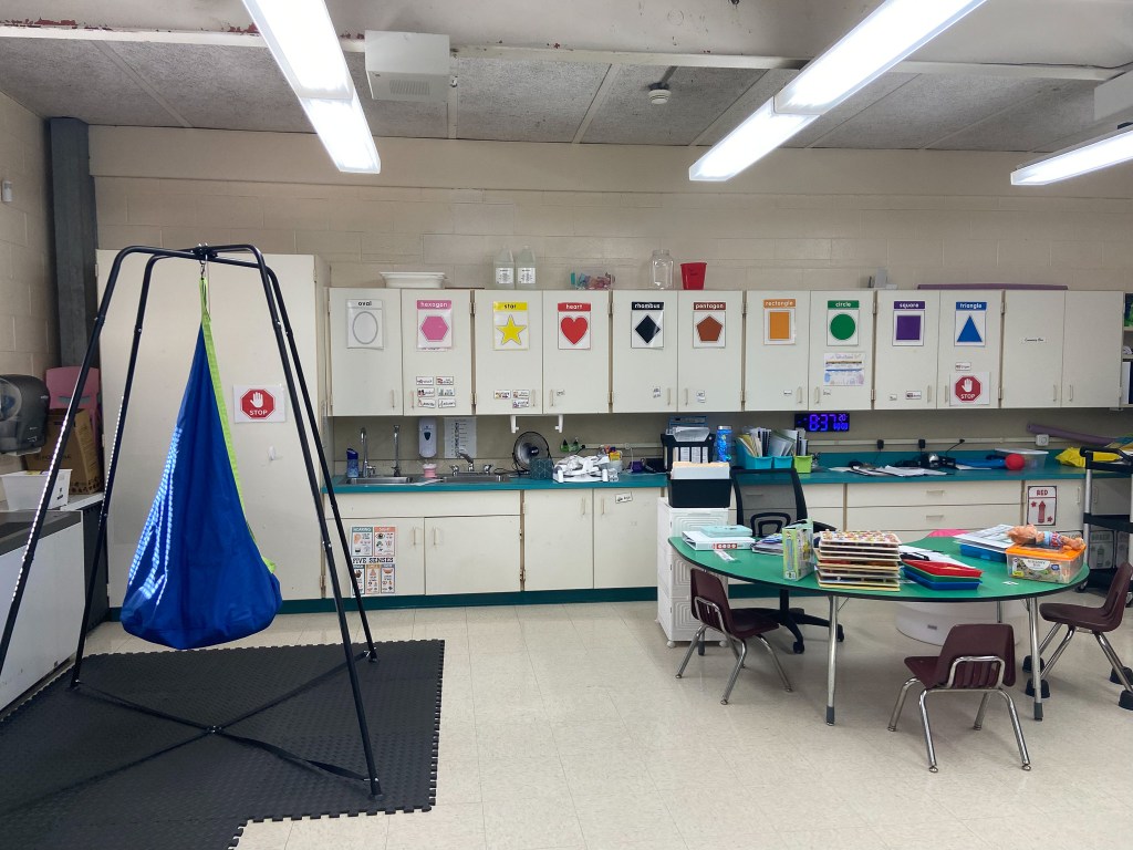 Early childhood special education classroom featuring a therapeutic swing and sensory learning supports.