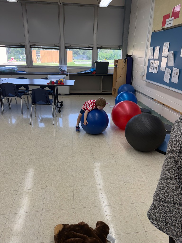 Young student using an exercise ball during a sensory activity at High Road School of the South Suburbs.