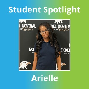 Excel Academy Central senior Arielle Johnson poses in front of an Excel Central Eagles backdrop, wearing a navy polo shirt and glasses.