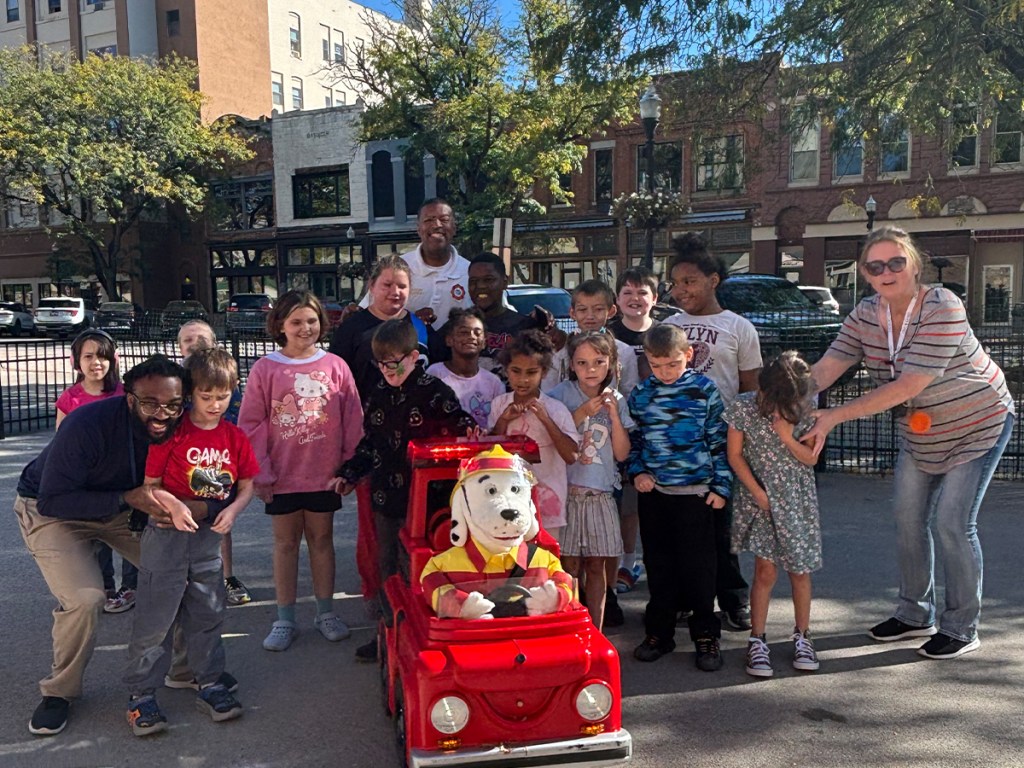 High Road School of Lima students and staff gather with a fire safety display during Fire Prevention Week.
