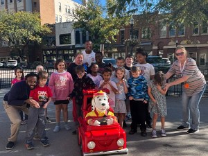 High Road School of Lima students and staff gather with a fire safety display during Fire Prevention Week.