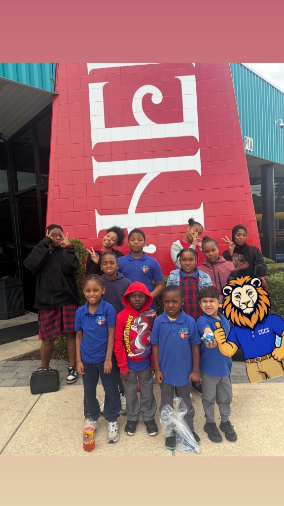 Students and staff from High Road School at Chester Community Charter School pose in front of a Herr’s Snack Factory Tour display.