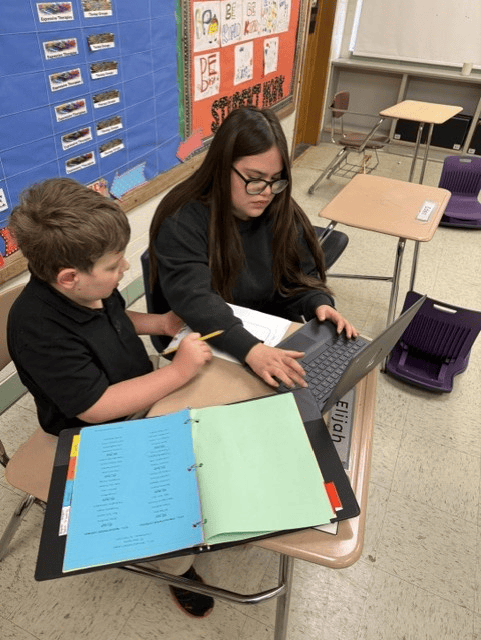 Two High Road School of Belvidere students working together on a laptop during class.