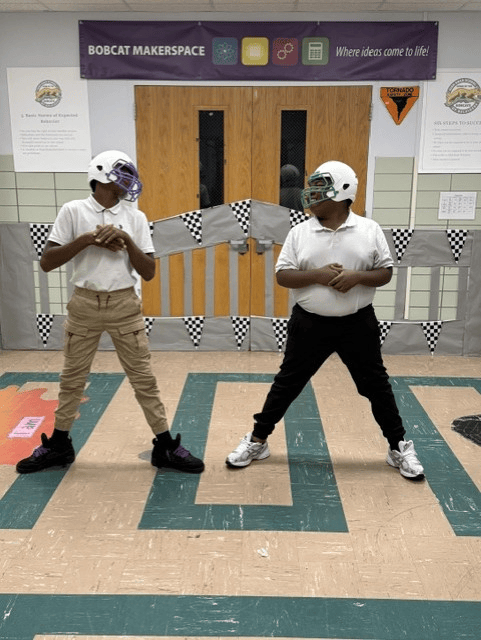Two High Road School of Belvidere students facing each other while wearing football helmets during an activity.
