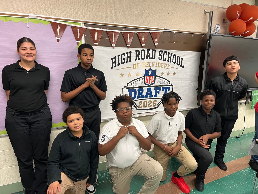 High Road School of Belvidere students posing in front of an NFL Draft 2026 display during the football curriculum kickoff.